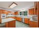 A well-lit kitchen shows honey oak cabinets, stainless appliances and a center island at 2110 Waterloo Cir, Lawrenceville, GA 30043