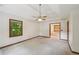 Bright main bedroom features a ceiling fan, neutral carpet, a large window, and an ensuite bathroom at 2110 Waterloo Cir, Lawrenceville, GA 30043