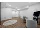Cozy basement space with wood-look flooring, accent rug, and comfortable seating near a television at 2432 Kelly Lake Dr, Decatur, GA 30032