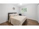 Bright bedroom with wood-look flooring, a cozy bed and bright natural light from the window at 2432 Kelly Lake Dr, Decatur, GA 30032