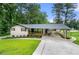 Charming single-story home with well-maintained lawn, covered front porch, and carport at 2432 Kelly Lake Dr, Decatur, GA 30032
