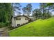 Beautiful single-story home nestled among trees, featuring a well-manicured lawn and covered porch at 2432 Kelly Lake Dr, Decatur, GA 30032