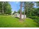 A charming home with a carport situated on a lot filled with mature trees and lush greenery at 2432 Kelly Lake Dr, Decatur, GA 30032