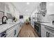 Open-concept kitchen with stainless appliances, white cabinets, and a view into the dining area at 2432 Kelly Lake Dr, Decatur, GA 30032
