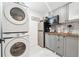Charming kitchenette featuring a stacked washer/dryer and modern gray cabinets with a butcher block countertop at 2432 Kelly Lake Dr, Decatur, GA 30032