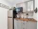 Compact kitchenette with gray cabinets, stainless steel appliances and butcher block countertops at 2432 Kelly Lake Dr, Decatur, GA 30032