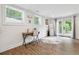 Bright office space with wood floors, a desk and a chair near the door to the backyard at 2432 Kelly Lake Dr, Decatur, GA 30032