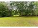 Spacious backyard featuring a lush lawn and mature trees at 265 Forest Lake Dr, Covington, GA 30016
