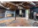 Unfinished basement with exposed ceiling and ductwork, a stainless steel refrigerator, and black painted walls at 265 Forest Lake Dr, Covington, GA 30016