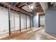 Unfinished basement with a mix of painted and unpainted walls, support beams, and exposed ceiling at 265 Forest Lake Dr, Covington, GA 30016