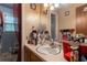 Bathroom with a single sink vanity, a decorative mirror, and wall decor, and a window at 265 Forest Lake Dr, Covington, GA 30016