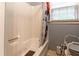 This is a bathtub with a white interior, a shower curtain hanging, and a window above the tub at 265 Forest Lake Dr, Covington, GA 30016