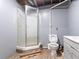 Bathroom featuring a standing shower, toilet, new floors and vanity at 265 Forest Lake Dr, Covington, GA 30016