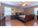 Comfortable bedroom featuring a ceiling fan and a dresser, with laminate flooring at 265 Forest Lake Dr, Covington, GA 30016