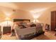 Bedroom features a bed with a padded headboard, side tables with lamps, and neutral carpeting at 265 Forest Lake Dr, Covington, GA 30016