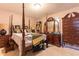 Bedroom featuring a four-poster bed, and wooden furniture at 265 Forest Lake Dr, Covington, GA 30016