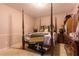 Bedroom featuring a four-poster bed, wooden furniture, and ceiling light at 265 Forest Lake Dr, Covington, GA 30016