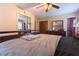 Bedroom featuring laminate floors, mirrored closet doors, and a ceiling fan with light at 265 Forest Lake Dr, Covington, GA 30016