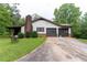 Exterior view of home showing attached two car garage and driveway at 265 Forest Lake Dr, Covington, GA 30016