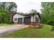 View of the home's attached two-car garage with an asphalt driveway at 265 Forest Lake Dr, Covington, GA 30016