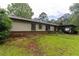 Spacious backyard of this home featuring ample green space and lots of plants and trees at 265 Forest Lake Dr, Covington, GA 30016
