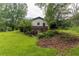 View of the rear exterior of this house, overgrown with foliage on a large lot at 265 Forest Lake Dr, Covington, GA 30016