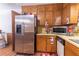 Kitchen with stainless steel refrigerator, wooden cabinets, and laminate countertops at 265 Forest Lake Dr, Covington, GA 30016