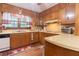 Functional kitchen with wooden cabinets, laminate countertops, and a white dishwasher at 265 Forest Lake Dr, Covington, GA 30016