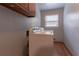 Laundry room featuring a washing machine, a window, and blue painted walls at 265 Forest Lake Dr, Covington, GA 30016