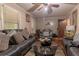 Spacious living room with comfortable leather sofas, hardwood floors, and a glass coffee table at 265 Forest Lake Dr, Covington, GA 30016