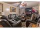 Inviting living room featuring comfortable leather seating, fireplace, and a ceiling fan with light at 265 Forest Lake Dr, Covington, GA 30016