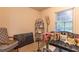 Cozy living room with a black leather couch, decorative pillows, and a glass coffee table at 265 Forest Lake Dr, Covington, GA 30016