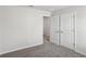Comfortable carpeted bedroom featuring a closet and two doorways leading to other rooms at 386 Tallulah Ln, Grayson, GA 30017
