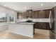 An open-concept kitchen features granite countertops, a center island, and stainless steel appliances at 386 Tallulah Ln, Grayson, GA 30017