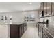 An open-concept kitchen features granite countertops, a center island, and stainless steel appliances at 386 Tallulah Ln, Grayson, GA 30017