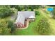 Pictureque aerial view of a well-kept house with a covered porch and green lawn at 3992 Spot Rd, Cumming, GA 30040