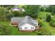 Aerial view of a beautiful brick and white home with a large yard, a deck, and mature trees at 3992 Spot Rd, Cumming, GA 30040