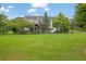 Spacious backyard with a deck, mature trees, and a well-maintained lawn, perfect for outdoor activities at 3992 Spot Rd, Cumming, GA 30040