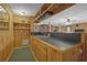 Finished basement features a bar area with knotty pine walls and shelving at 3992 Spot Rd, Cumming, GA 30040