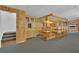 Cozy basement bar area with wood paneling, custom cabinetry, and seating for a relaxing ambiance at 3992 Spot Rd, Cumming, GA 30040