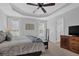 Serene bedroom with tray ceilings, neutral colors, and ample natural light at 3992 Spot Rd, Cumming, GA 30040