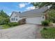 Charming home featuring a large garage, well-maintained landscaping, and a neatly paved driveway at 3992 Spot Rd, Cumming, GA 30040