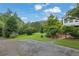 Expansive front yard featuring lush green grass and mature trees, showcasing the property's serene landscaping at 3992 Spot Rd, Cumming, GA 30040
