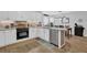 Bright kitchen features white cabinets, modern appliances, and a dining area with natural light at 3992 Spot Rd, Cumming, GA 30040