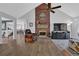 Living room with brick fireplace, vaulted ceilings, and hardwood-style flooring at 3992 Spot Rd, Cumming, GA 30040