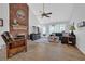 Bright living room features a brick fireplace, ceiling fan, and hardwood-style flooring at 3992 Spot Rd, Cumming, GA 30040