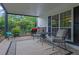 Cozy covered patio with outdoor seating, a grill, and lush greenery providing a tranquil backyard retreat at 3992 Spot Rd, Cumming, GA 30040