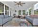 Inviting sunroom filled with natural light, comfortable seating, and a ceiling fan at 3992 Spot Rd, Cumming, GA 30040