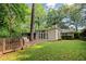 Charming home featuring a lush backyard with a wooden deck and large windows at 5114 N Ivy Ne Rd, Atlanta, GA 30342