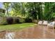 Deck with seating overlooks a grassy backyard with a wood fence at 5114 N Ivy Ne Rd, Atlanta, GA 30342